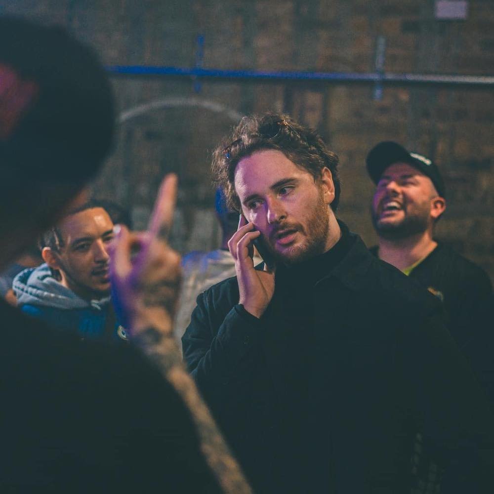 Shuffle T on the phone in a rap battle with Shotty Horroh, Tony D and Bloodstro in shot